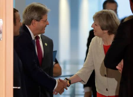 Italian Prime Minister Paolo Gentiloni, welcomes British Prime Minister Theresa May prior to a gathering of European leaders on the upcoming G-20 summit in the chancellery in Berlin, Germany, June 29, 2017. REUTERS/Markus Schreiber/POOL