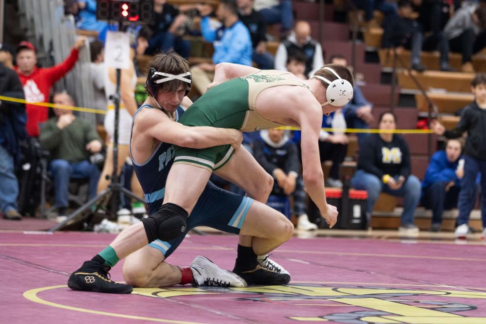 John Jay's Brandon DellaPia, left wrestles Longwood's Jack Kent, right in the 57th Mid-Hudson wrestling Tournament in LaGrange, NY on December 28, 2023.