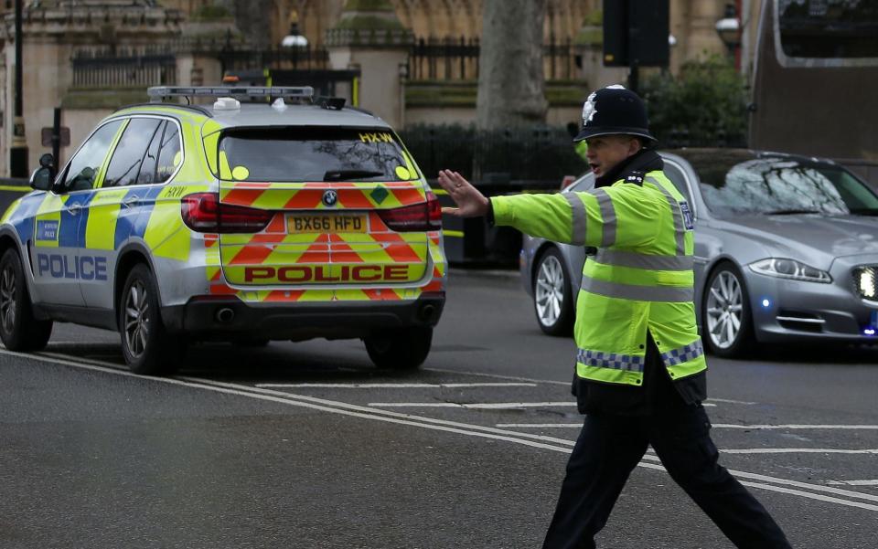 A police officer stops traffic as the Jaguar car of Theresa May is driven away from the Houses of Parliament - Credit: DANIEL LEAL-OLIVAS/AFP