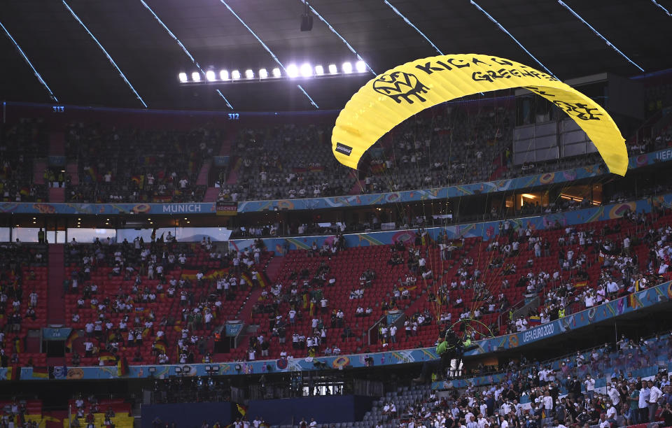 Paraglider soars through the air prior the start of the Euro 2020 soccer championship group F match between Germany and France at the Allianz Arena stadium in Munich, Tuesday, June 15, 2021. (Franck Fife/Pool via AP)