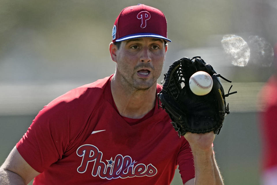 Philadelphia Phillies pitcher Mark Appel fields a ground ball during a spring training baseball workout Tuesday, Feb. 21, 2023, in Clearwater, Fla. (AP Photo/David J. Phillip)