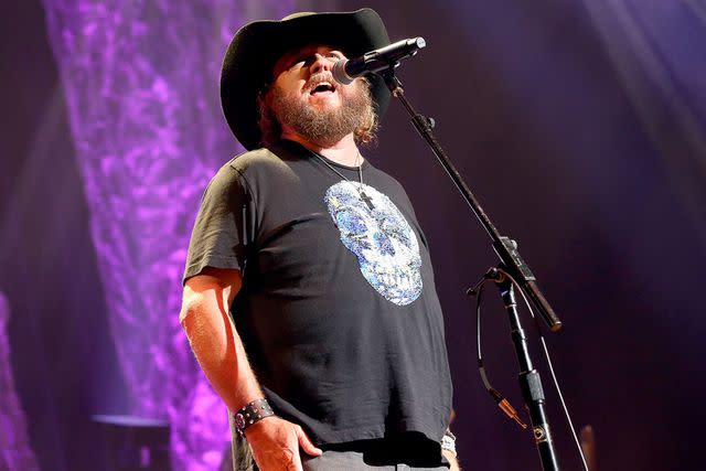 <p>Terry Wyatt/Getty</p> Colt Ford performs on stage in Atlanta in July 2019