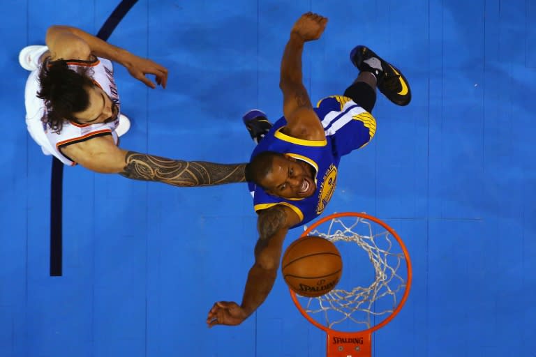 Andre Iguodala of the Golden State Warriors shoots the ball against Steven Adams of the Oklahoma City Thunder during game six of the Western Conference Finals