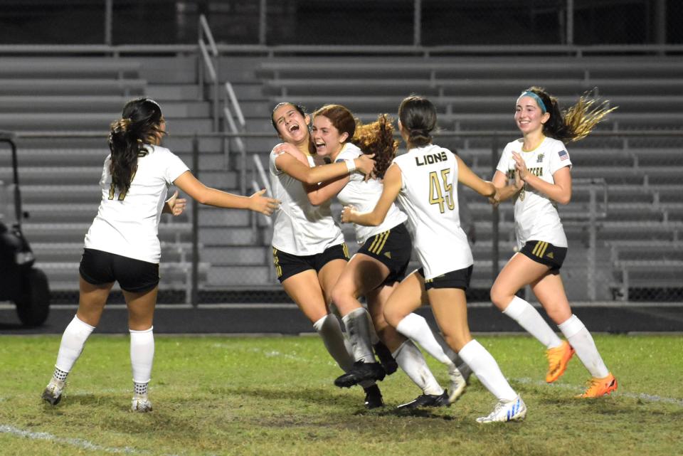 Olympic Heights soccer players celebrate a goal scored during a regular season game against Spanish River in 2023.