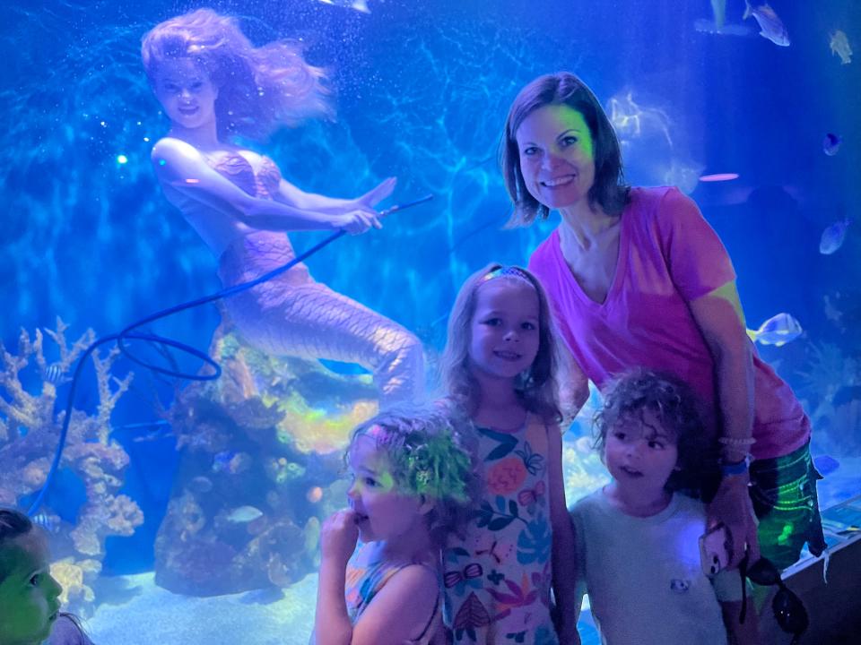 Mermaid Serena, left, poses with the Bailey family at Mertailor’s Mermaid Aquarium Encounter in
Citrus County southwest of Ocala on Florida's Gulf Coast.