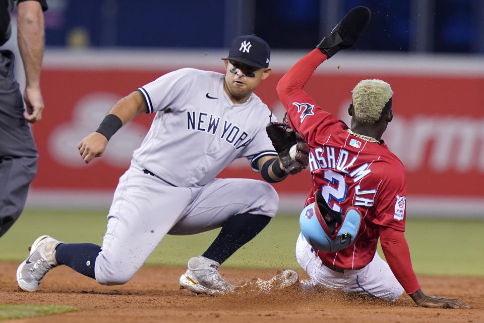 Miami Marlins' Jazz Chisholm (2) is tagged out by New York Yankees second baseman Rougned Odor, left, while stealing second during the third inning of a baseball game, Sunday, Aug. 1, 2021, in Miami. (AP Photo/Lynne Sladky)