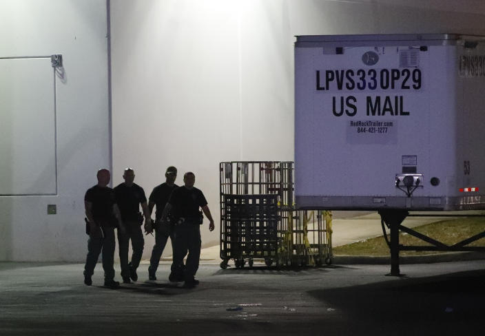 <p>Members of the Miami-Dade County Bomb Squad walk outside a postal facility, Thursday, Oct. 25, 2018, in Opa-locka, Fla. Investigators searched coast-to-coast Thursday for the culprit and motives behind the bizarre mail-bomb plot aimed at critics of the president. (Photo: Wilfredo Lee/AP) </p>