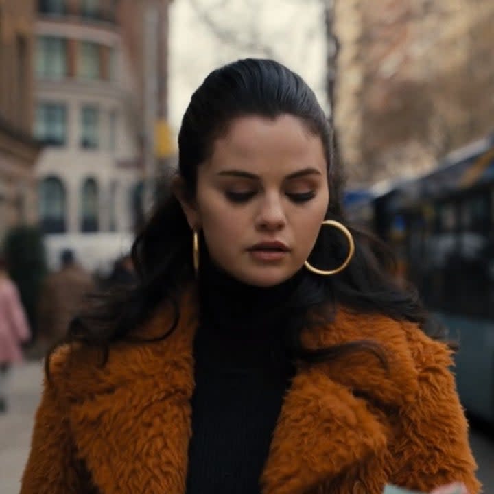 Photo of Selena Gomez as Mabel in a brown fluffy coat and peach eyeshadow