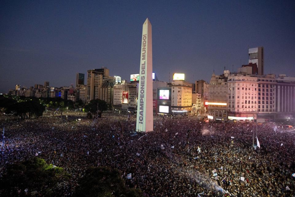 A message reading in Spanish ¨Champions of the World¨is projected on the capital's Obelisk as fans celebrate their team's World Cup victory over France in Buenos Aires, Argentina, Sunday, Dec. 18, 2022. (AP Photo/Victor Caivano)