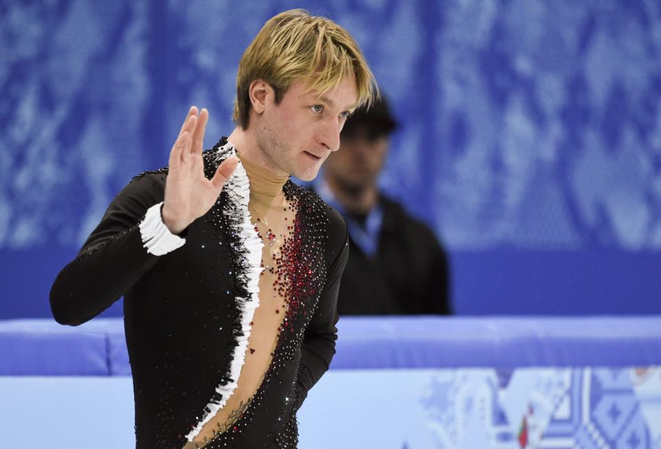 Evgeni Plushenko of Russia, waves as he leaves the ice after withdrawing from the men's figure skating competition due to illness at the Iceberg Skating Palace during the 2014 Winter Olympics, Thursday, Feb. 13, 2014, in Sochi, Russia. (AP Photo/The Canadian Press, Paul Chiasson)