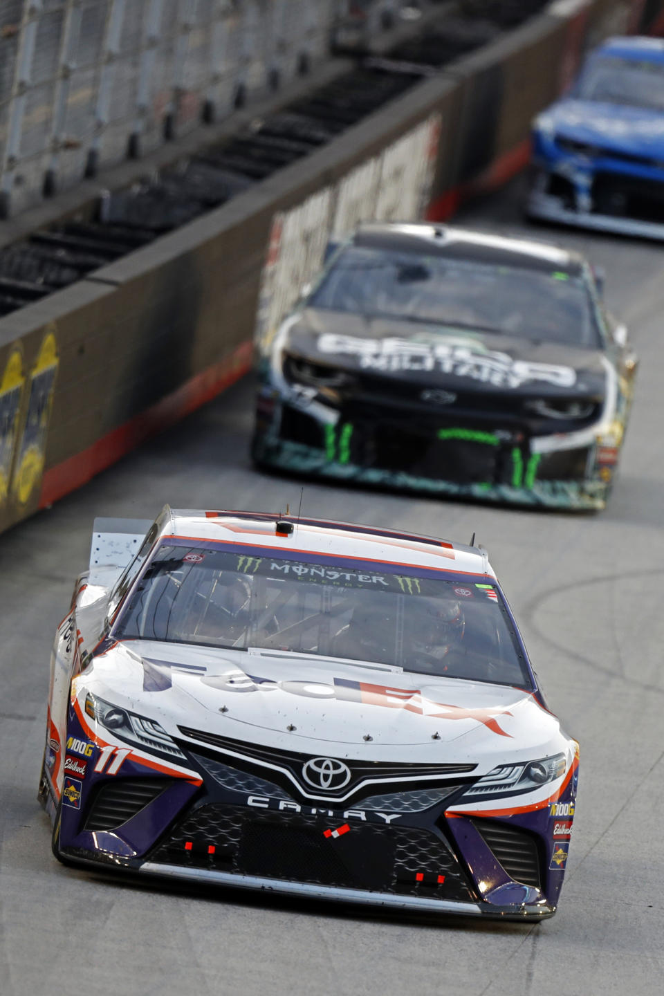 Denny Hamlin (11) leads the field down the back straight during a NASCAR Cup Series auto race Saturday, Aug. 17, 2019, in Bristol, Tenn. (AP Photo/Wade Payne)