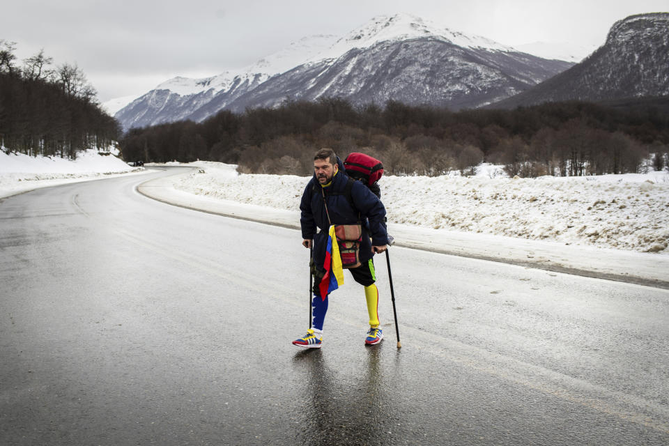 Venezuelan Yeslie Aranda, 57, walks on Route 3 between Tolhuin and Ushuaia, Argentina, Saturday, Aug. 17, 2019. Aranda left his hometown of San Cristobal in the southeastern state of Táchira last year with a backpack, $30 in his pocket and an aluminum prosthesis that enabled him to negotiate the continent’s rugged roads. (AP Photo/Luján Agusti)