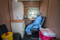 A medical worker records patients who received Covid-19 vaccine in a train at the Swartkops railroad yard outside Gqeberha, South Africa, Thursday Sept. 23, 2021. South Africa has sent a train carrying COVID-19 vaccines into one of its poorest provinces to get doses to areas where healthcare facilities are stretched. The vaccine train, named Transvaco, will go on a three-month tour through the Eastern Cape province and stop at seven stations for two weeks at a time to vaccinate people. (AP Photo/Jerome Delay)