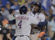 <p>Houston Astros center fielder George Springer (4) celebrates with teammate Cameron Maybin (3) after hitting a two-run home run against the Los Angeles Dodgers in the 11th inning in game two of the 2017 World Series at Dodger Stadium. Mandatory Credit: Gary A. Vasquez-USA TODAY Sports </p>