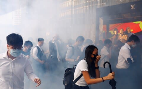 Office workers react after police fired tear gas, in Central, Hong Kong - Credit: &nbsp;REUTERS/Thomas Peter