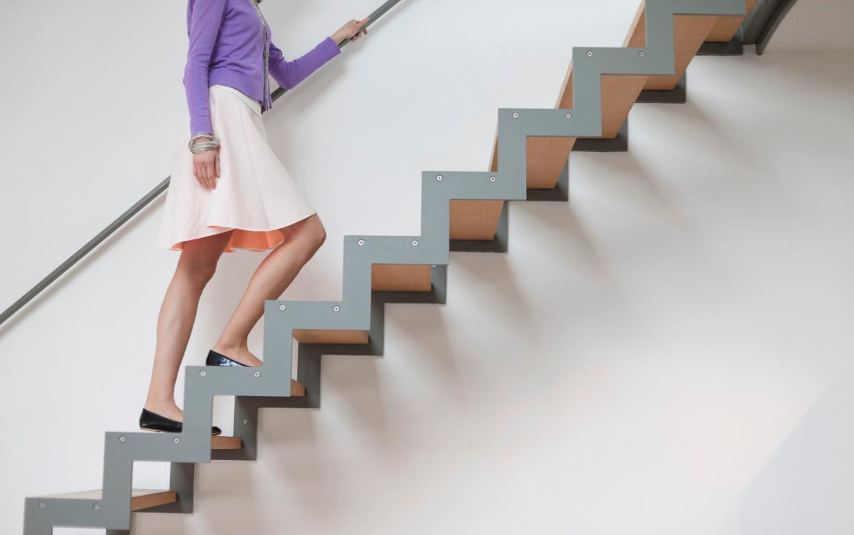 A woman walking up stairs - Climb the stairs before you do the crossword to help solve clues, study finds