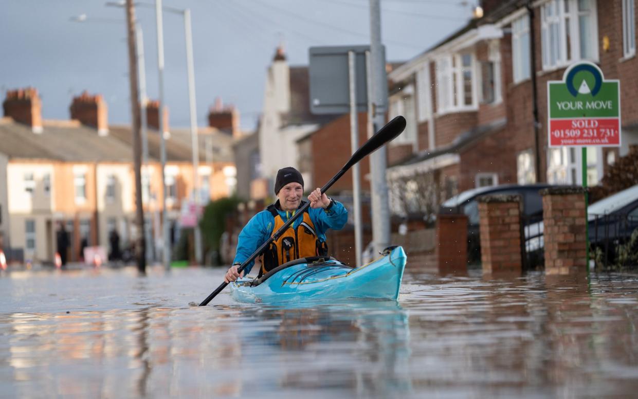 A local goes out on his kayak in Loughborough, where homes have flooded after the Grand Union Canal burst its banks