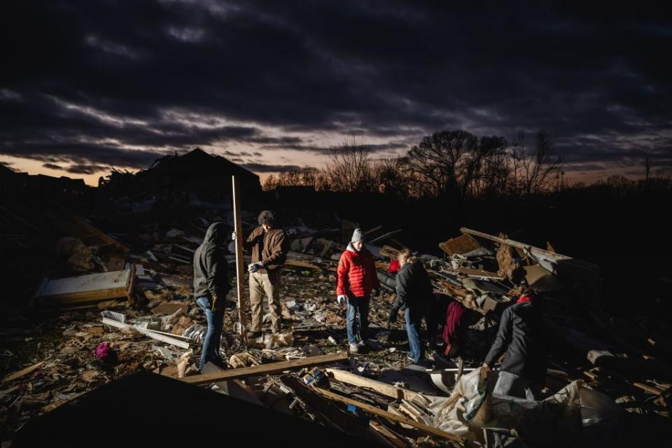 Residents and visitors work to clear debris in Clarksville, Tennessee.