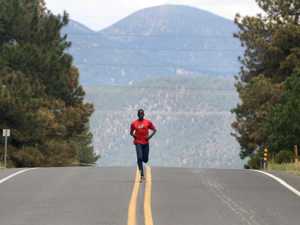 Guor Marial runs along a street in Flagstaff, Arizona
