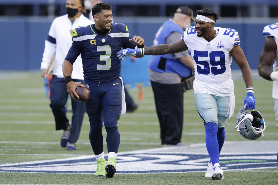 Seattle Seahawks quarterback Russell Wilson (3) greets Dallas Cowboys linebacker Justin March (59) after the Seahawks beat the Cowboys 38-31 in an NFL football game, Sunday, Sept. 27, 2020, in Seattle. (AP Photo/John Froschauer)