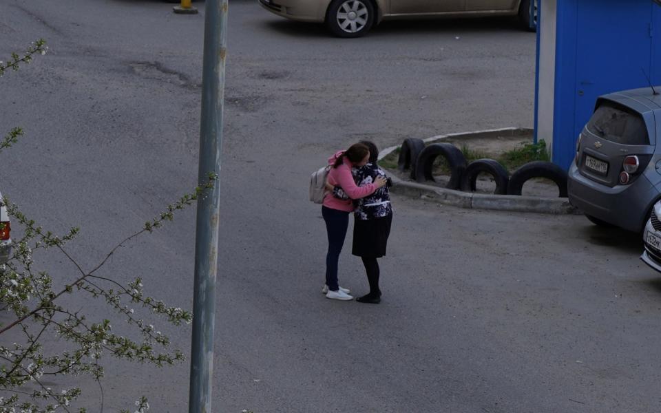 Parent embraces her child after the deadly shooting -  MAX ZARECKIY/Reuters