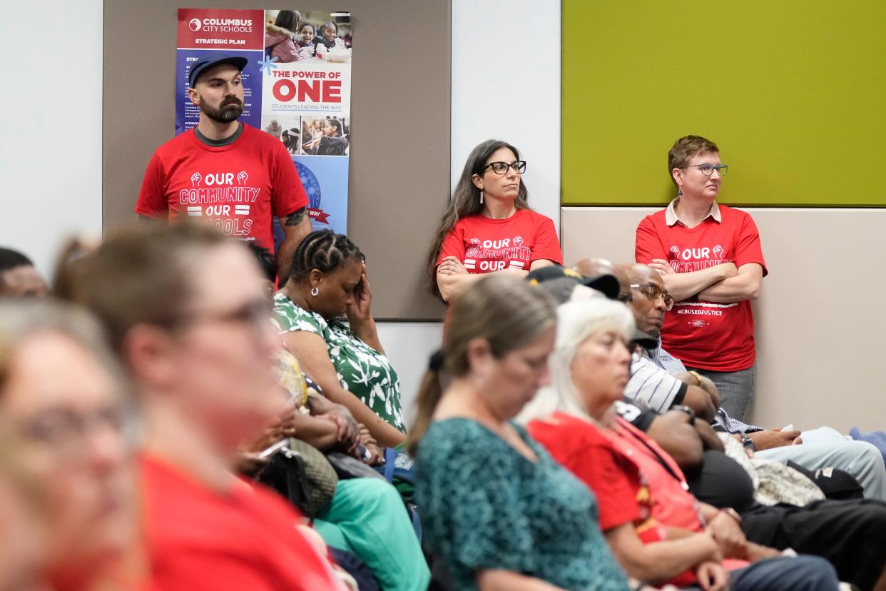 A capacity crowd listens Tuesday as the preliminary proposal from the Superintendent's Facilities Task Force about the potential closings of schools is presented at a Columbus City Schools board meeting. An overflow room was set up due number of people in attendance.