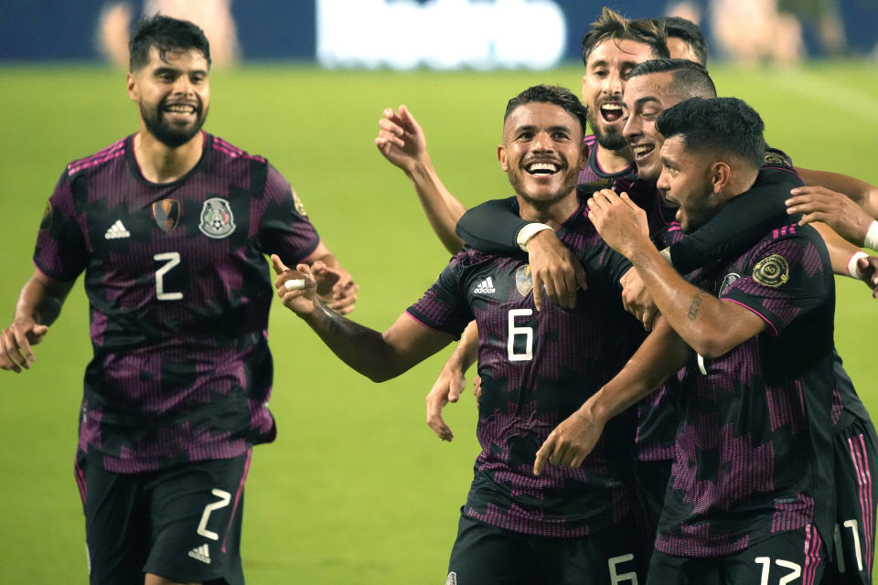 Mexico midfielder Jonathan Dos Santos (6) celebrates with teammates after scoring a goal against Honduras during the first half of a CONCACAF Gold Cup soccer match, Saturday, July 24, 2021, in Glendale, Ariz. (AP Photo/Rick Scuteri)