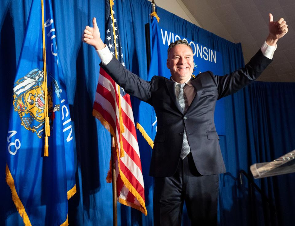 Tim Michels bounds on stage to claim victory in the Republican primary for governor Tuesday, Aug. 9, 2022, at Tuscan Hall Venue and Catering in Waukesha, Wis. He will face incumbent Gov. Tony Evers, a Democrat, in the general election.