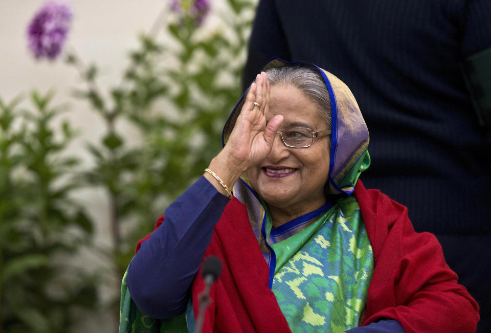 Bangladeshi Prime Minister Sheikh Hasina greets the gathering during an interaction with journalists in Dhaka, Bangladesh, Monday, Dec. 31, 2018. Bangladesh's ruling alliance won virtually every parliamentary seat in the country's general election, according to official results released Monday, giving Hasina a third straight term despite allegations of intimidation and the opposition disputing the outcome. (AP Photo/Anupam Nath)