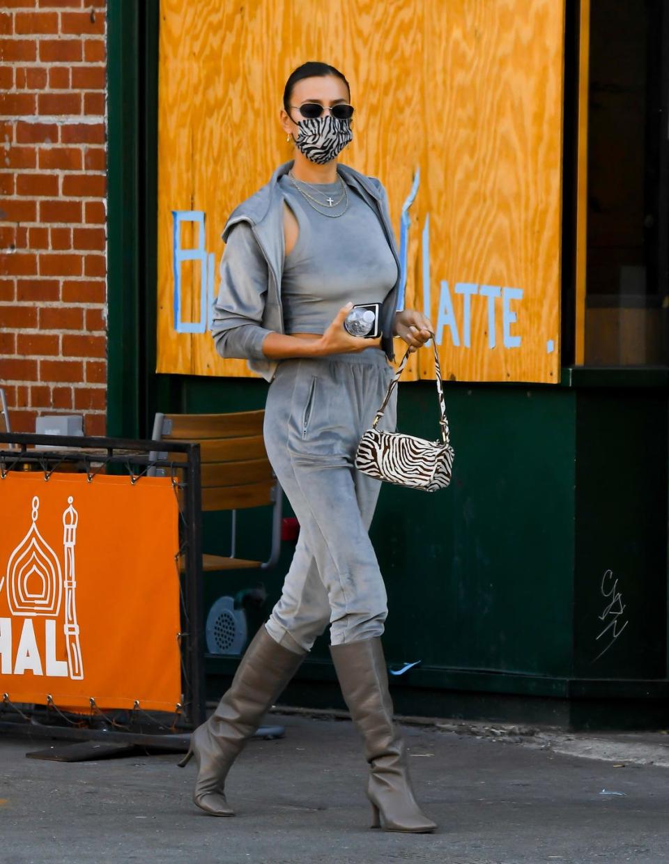 <p>The supermodel was spotted running errands and picking up coffee in New York City on November 9 wearing the comfiest of outfits during the pandemic.</p><p>The 34-year-old wore a grey velour tracksuit from <a href="https://www.elle.com/uk/life-and-culture/g34434604/kim-kardashian-career/" rel="nofollow noopener" target="_blank" data-ylk="slk:Kim Kardashian;elm:context_link;itc:0;sec:content-canvas" class="link ">Kim Kardashian</a>’s shapewear brand <a href="https://www.elle.com/uk/life-and-culture/culture/a33940186/kim-kardashian-homeware-interiors-business/" rel="nofollow noopener" target="_blank" data-ylk="slk:SKIMS;elm:context_link;itc:0;sec:content-canvas" class="link ">SKIMS</a> which consisted of a <a href="https://skims.com/products/velour-hoodie-smoke" rel="nofollow noopener" target="_blank" data-ylk="slk:hoodie;elm:context_link;itc:0;sec:content-canvas" class="link ">hoodie</a>, <a href="https://skims.com/products/velour-crew-neck-tank-smoke" rel="nofollow noopener" target="_blank" data-ylk="slk:crew neck vest top;elm:context_link;itc:0;sec:content-canvas" class="link ">crew neck vest top</a> and jogging <a href="https://skims.com/products/velour-jogger-smoke" rel="nofollow noopener" target="_blank" data-ylk="slk:bottoms;elm:context_link;itc:0;sec:content-canvas" class="link ">bottoms</a>. She teamed the look with a zebra-print mask and matching printed handbag, black sunglasses and grey pointed knee-high boots.</p><p><a class="link " href="https://www.marksandspencer.com/pure-cashmere-textured-joggers/p/clp60459655?color=GREYMIX" rel="nofollow noopener" target="_blank" data-ylk="slk:SHOP GREY CASHMERE JOGGERS;elm:context_link;itc:0;sec:content-canvas">SHOP GREY CASHMERE JOGGERS</a></p><p><a class="link " href="https://www.net-a-porter.com/en-gb/shop/product/gianvito-rossi/85-suede-knee-boots/1289482" rel="nofollow noopener" target="_blank" data-ylk="slk:SHOP SIMILAR GREY BOOTS;elm:context_link;itc:0;sec:content-canvas">SHOP SIMILAR GREY BOOTS</a></p>