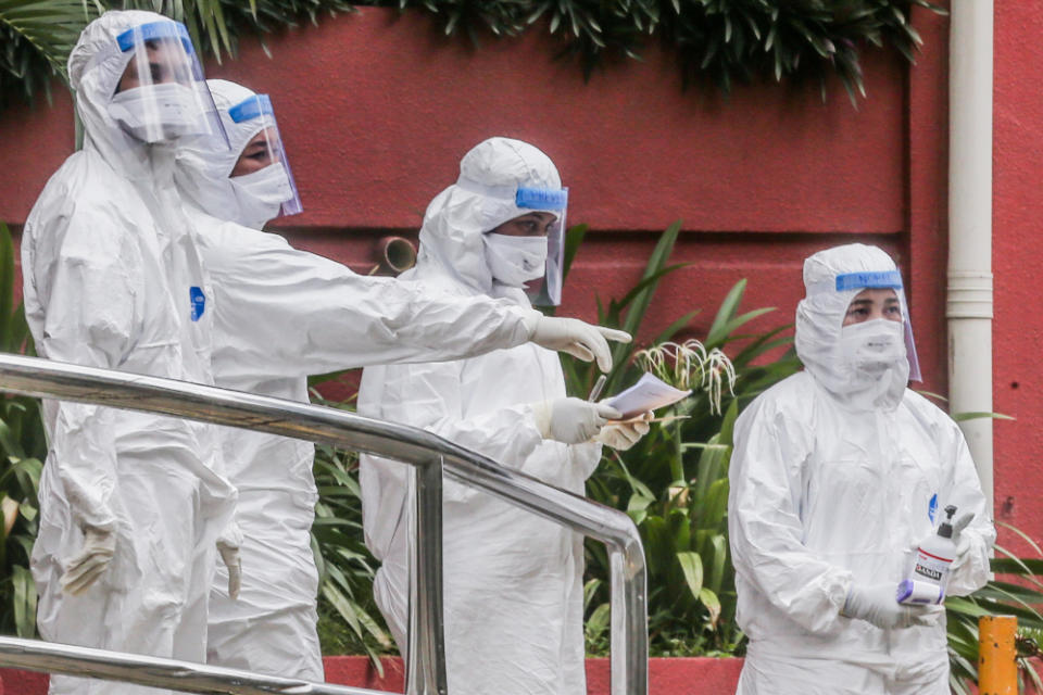 Health workers are seen at Menara City One during the enhanced movement control order (EMCO) in Kuala Lumpur April 5, 2020. — Picture by Firdaus Latif