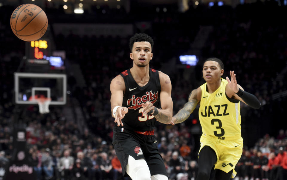 Portland Trail Blazers forward Toumani Camara, left, passes the ball as Utah Jazz guard Keyonte George, defends during the first half of an NBA basketball game in Portland, Ore., Wednesday, Nov. 22, 2023. (AP Photo/Steve Dykes)