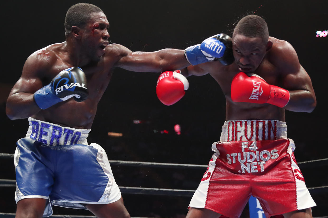 Andre Berto (L) lands a left hand against Devon Alexander during a PBC on Fox bout at the Nassau Veterans Memorial Coliseum on Aug. 4, 2018 in Uniondale, New York. (Getty Images)