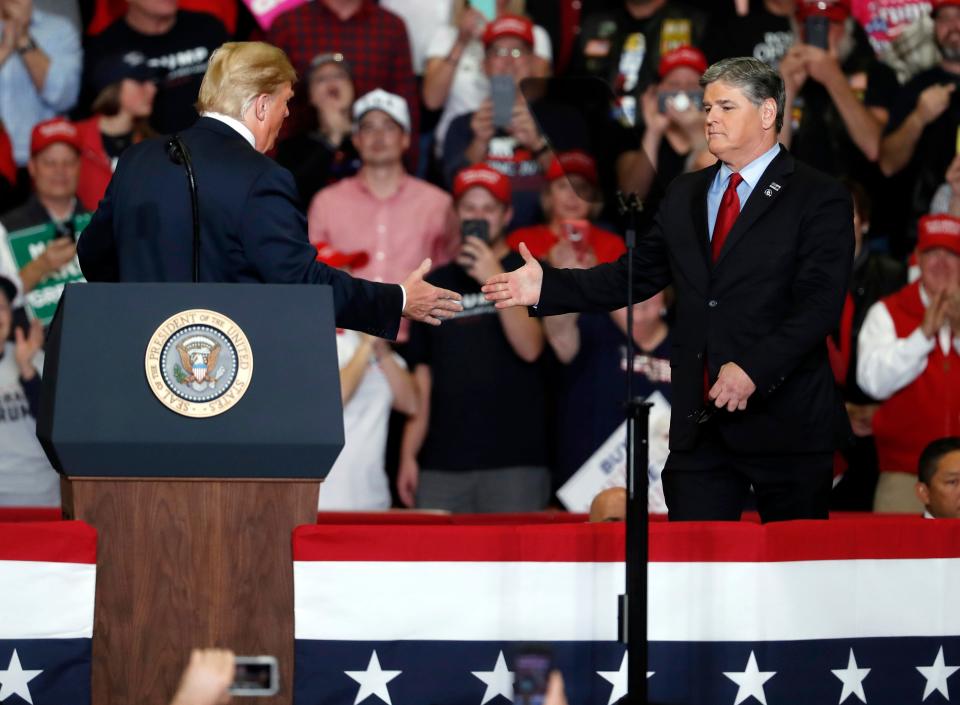 President Donald Trump greets Fox News' Sean Hannity at a campaign rally on Nov. 5, 2018, in Cape Girardeau, Missouri.