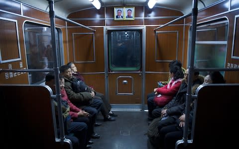 Portraits of North Korea's former leaders even make their way into the subway carriages - Credit: Eddie Mulholland