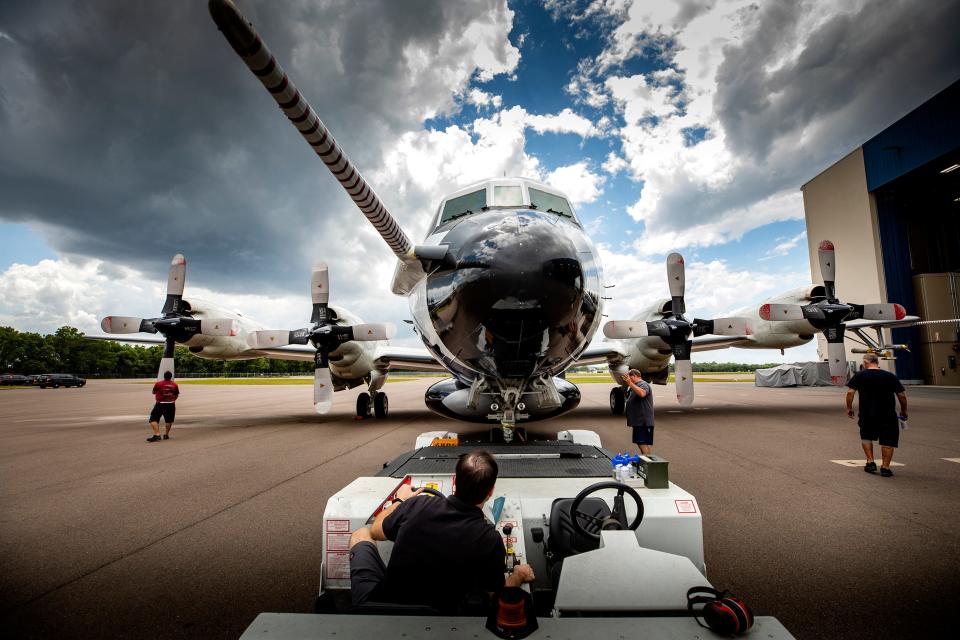 The NOAA hurricane hunter P3 Orion aircraft is towed back into their hangar after engine testing at NOAA's Aircraft Operations Center at Lakeland Linder Airport in Lakeland. NOAA crews are preparing their aircraft for the upcoming hurricane season. ERNST PETERS/ THE LEDGER