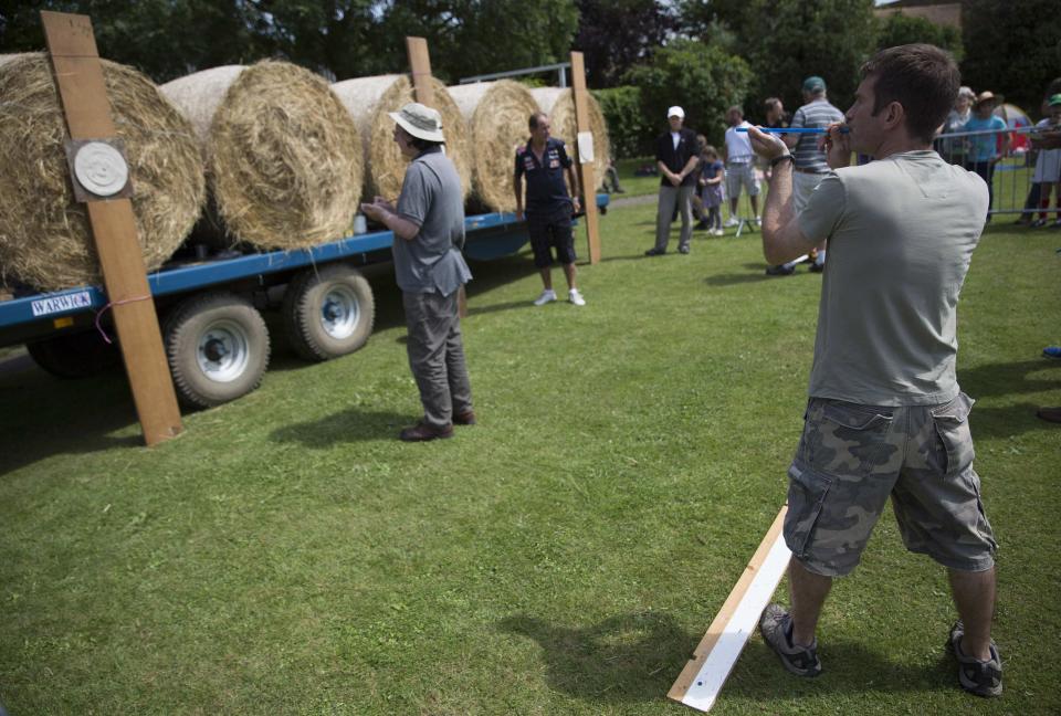 A competitor takes aim during the 2014 World Pea Shooting Championship in Witcham, southern England July 12, 2014. The annual competition has been held in the village since 1971 and attracts participants from across the globe.