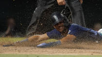 Seattle Mariners' Julio Rodriguez scores on a sacrifice fly by Jesse Winker during the sixth inning of the team's baseball game against the Los Angeles Angels on Tuesday, Aug. 16, 2022, in Anaheim, Calif. (AP Photo/Marcio Jose Sanchez)
