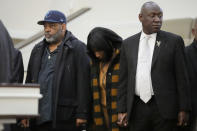 RowVaughn Wells, mother of Tyre Nichols, who died after being beaten by Memphis police officers, and Tyre's stepfather Rodney Wells, left, hold hands during a prayer at a news conference with civil rights Attorney Ben Crump in Memphis, Tenn., Friday, Jan. 27, 2023. (AP Photo/Gerald Herbert)