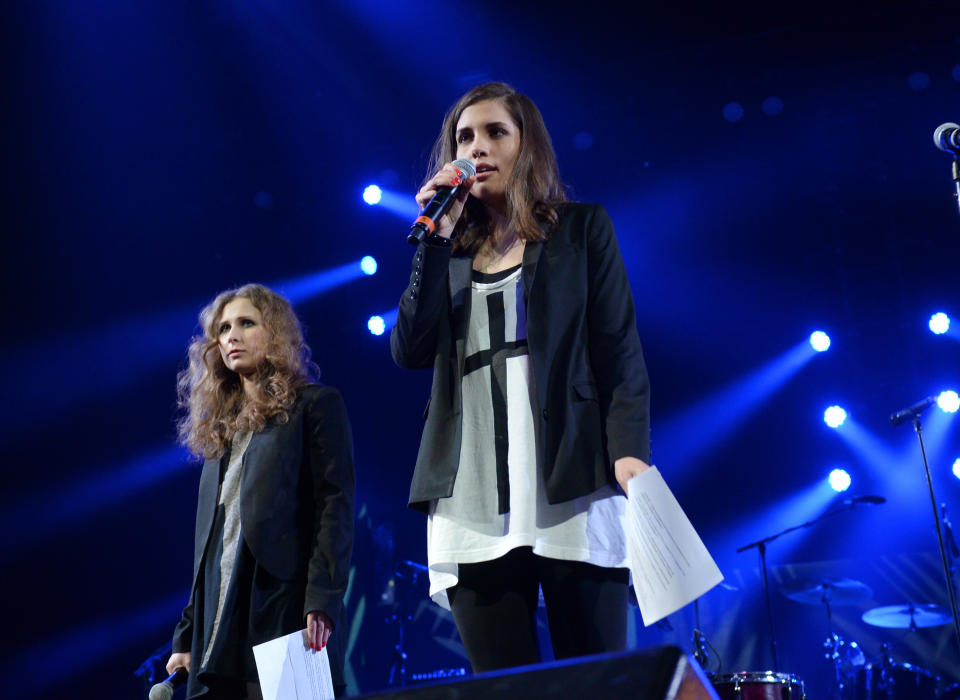 Members of Pussy Riot, Maria Alekhina, left, and Nadya Tolokonnikova speak at Amnesty International's "Bringing Human Rights Home" Concert at the Barclays Center on Wednesday, Feb. 5, 2014 in New York. (Photo by Evan Agostini/Invision/AP)