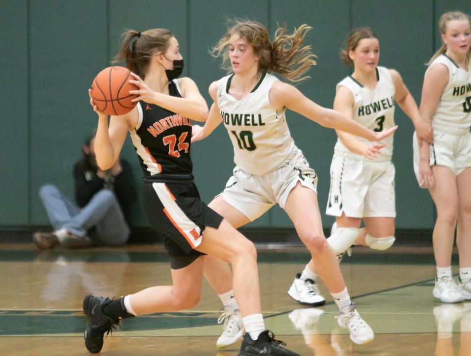 Northville's Evelyn Deren is guarded by Amelia Storm of Howell on Tuesday, Jan. 18, 2022.