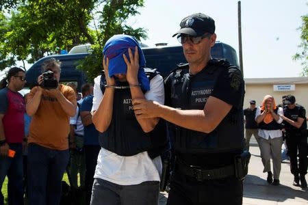 One of the eight Turkish soldiers who fled to Greece in a helicopter and requested political asylum after a failed military coup against the government, is escorted to the courthouse of the northern city of Alexandroupolis, Greece, July 21, 2016. REUTERS/Antonis Pasvantis