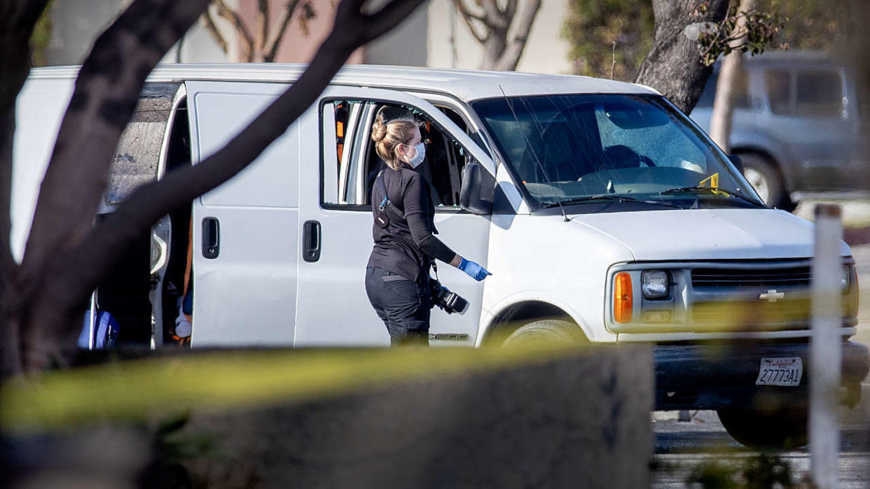 Torrance, CA - January 22:  A coroner official investigates the scene where police say a man slumped over the wheel of a white van, apparently deceased due to a self-inflicted gunshot, is connected to Saturday nights Lunar New Year mass shooting in Monterey Park. Torrance SWAT officers surrounded the van as the driver appeared slumped over the wheel in Torrance Sunday, Jan. 22, 2023. At least two bullet holes had been visible in the drivers-side window. Just before 1 p.m. Sunday, a SWAT team swarmed the vehicle and smashed its windows in the parking lot of Tokyo Central, a Japanese grocery store near the southwest corner of Hawthorne and Sepulveda boulevards.  (Allen J. Schaben / Los Angeles Times via Getty Images)