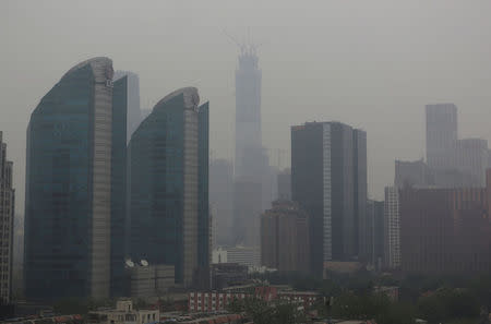 The construction site of China Zun, should be the tallest building in Beijing, is seen in smog, China April 16, 2017. REUTERS/Jason Lee