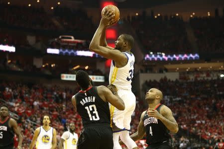 May 14, 2018; Houston, TX, USA; Golden State Warriors forward Kevin Durant (35) shoots over Houston Rockets guard James Harden (13) and forward PJ Tucker (4) during the fourth quarter in game one of the Western conference finals of the 2018 NBA Playoffs at Toyota Center. Mandatory Credit: Troy Taormina-USA TODAY Sports
