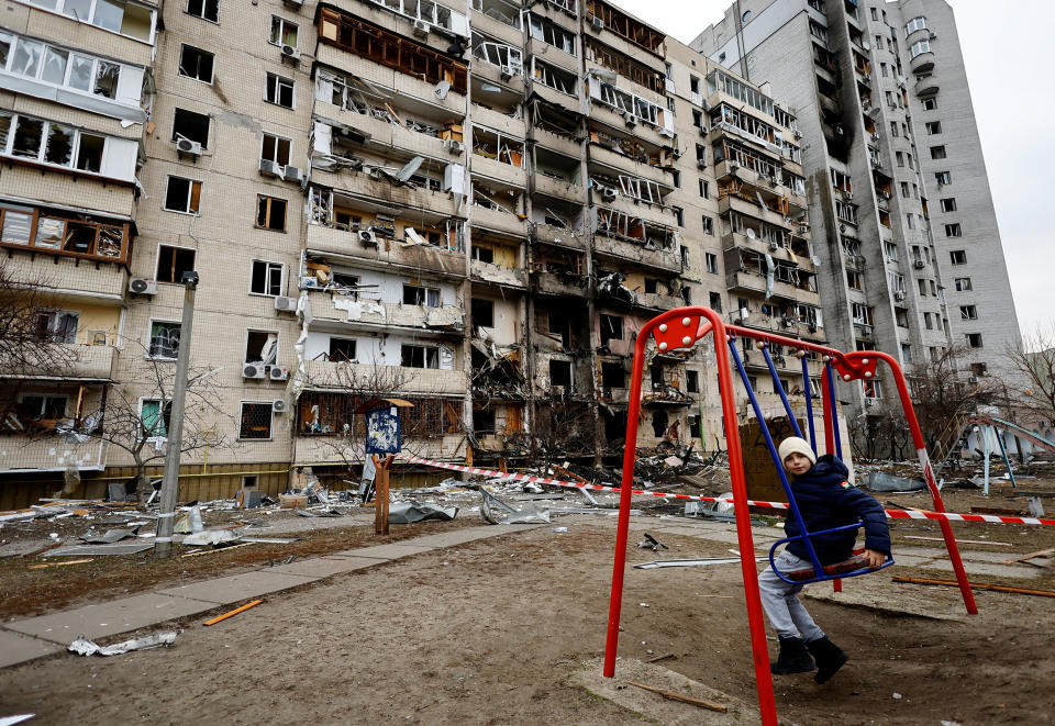 Image: A residential building is damaged, after Russia launched a massive military operation against Ukraine, in Kyiv (Umit Bektas / Reuters)