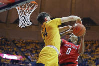 Texas Tech guard Kyler Edwards (0) goes to shoot as he is defended by West Virginia guard Chase Harler (14) during the first half of an NCAA college basketball game Saturday, Jan. 11, 2020, in Morgantown, W.Va. (AP Photo/Kathleen Batten)