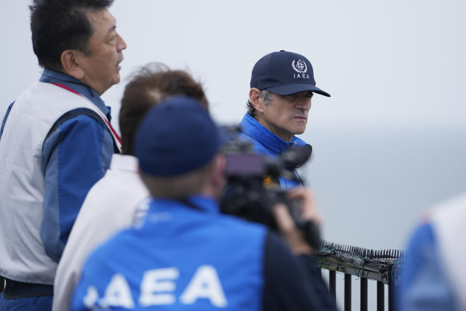 Rafael Mariano Grossi, right, Director General of the International Atomic Energy Agency, listens to Tomoaki Kobayakawa, President of Tokyo Electric Power Co., left, explain facilities to be used to release treated wastewater while visiting the damaged Fukushima nuclear power plant in Futaba, northeastern Japan, Wednesday, July 5, 2023. (AP Photo/Hiro Komae, Pool)