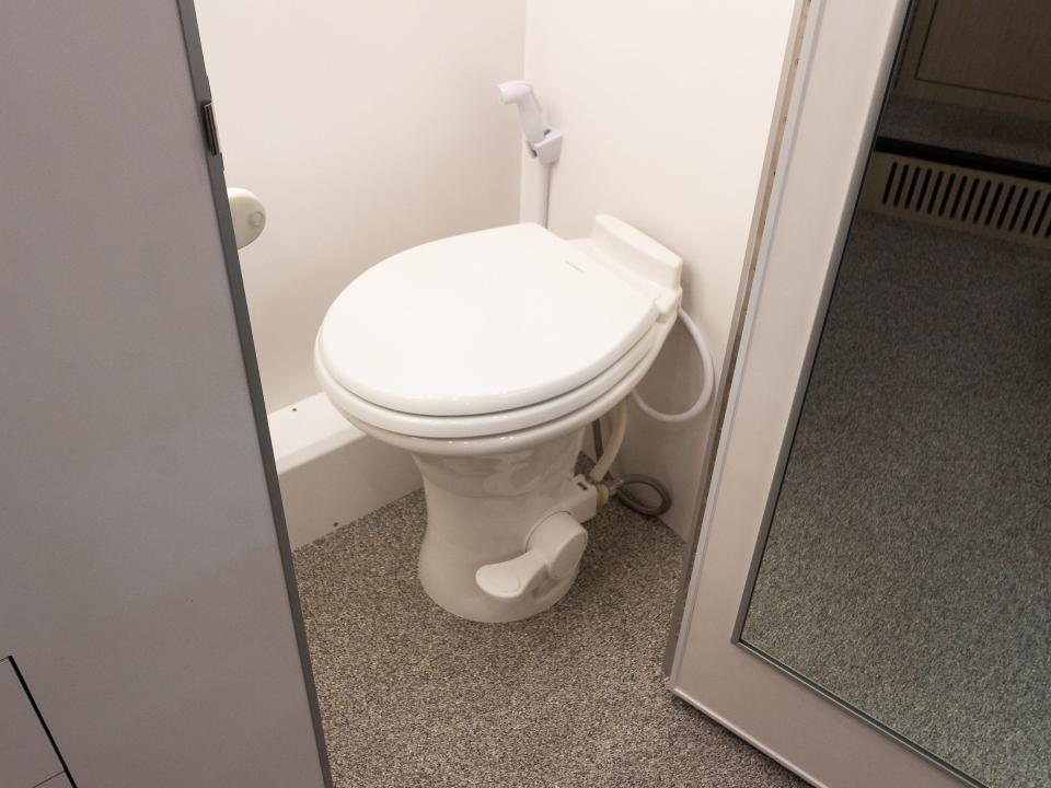 a toilet behind a door