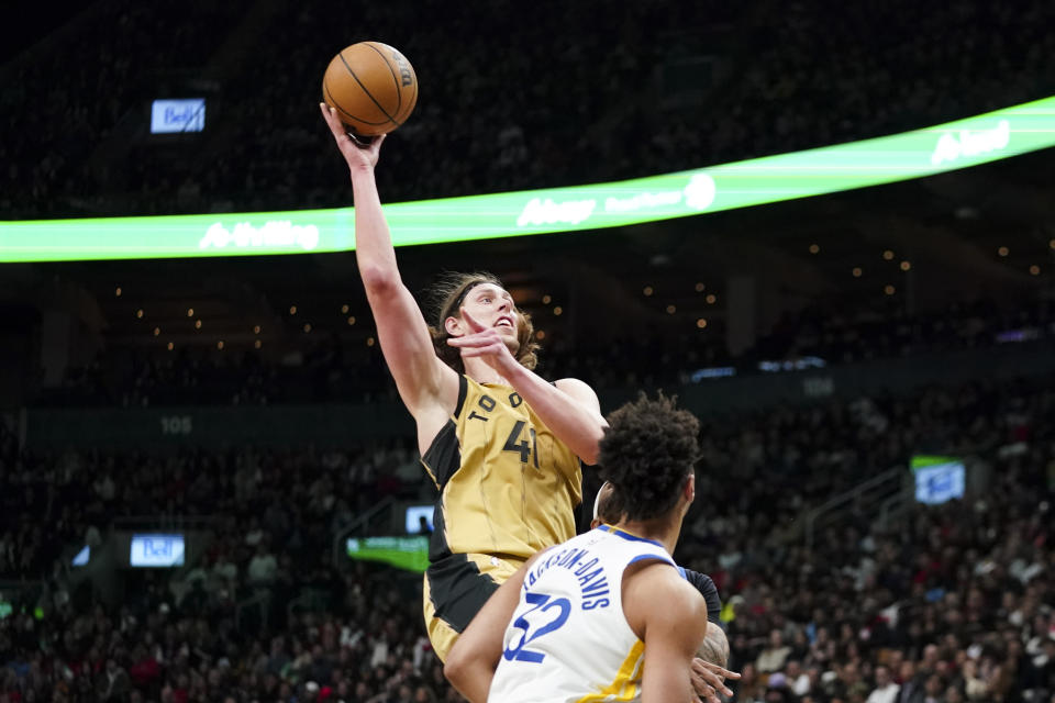 Toronto Raptors forward Kelly Olynyk (41) shoots as Golden State Warriors forward Trayce Jackson-Davis (32) looks on during the second half of an NBA basketball game in Toronto, Friday, March 1, 2024. (Arlyn McAdorey/The Canadian Press via AP)